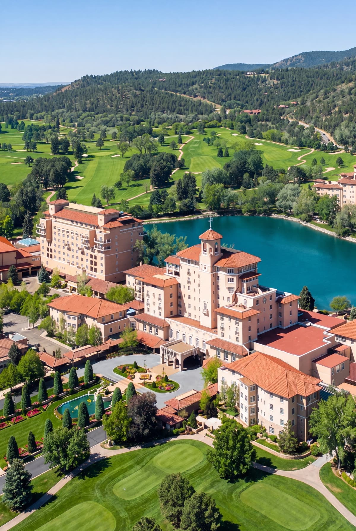 Aerial view of The Broadmoor resort, Cheyenne Lake and the golf grounds ringed by the front range