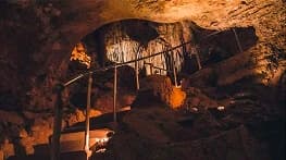 Lit formations and a walkway inside Cave of the Winds