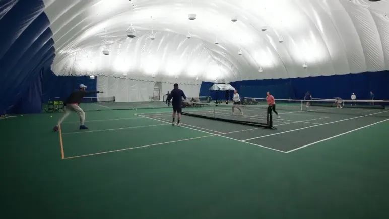 A pickleball rally under the tennis dome