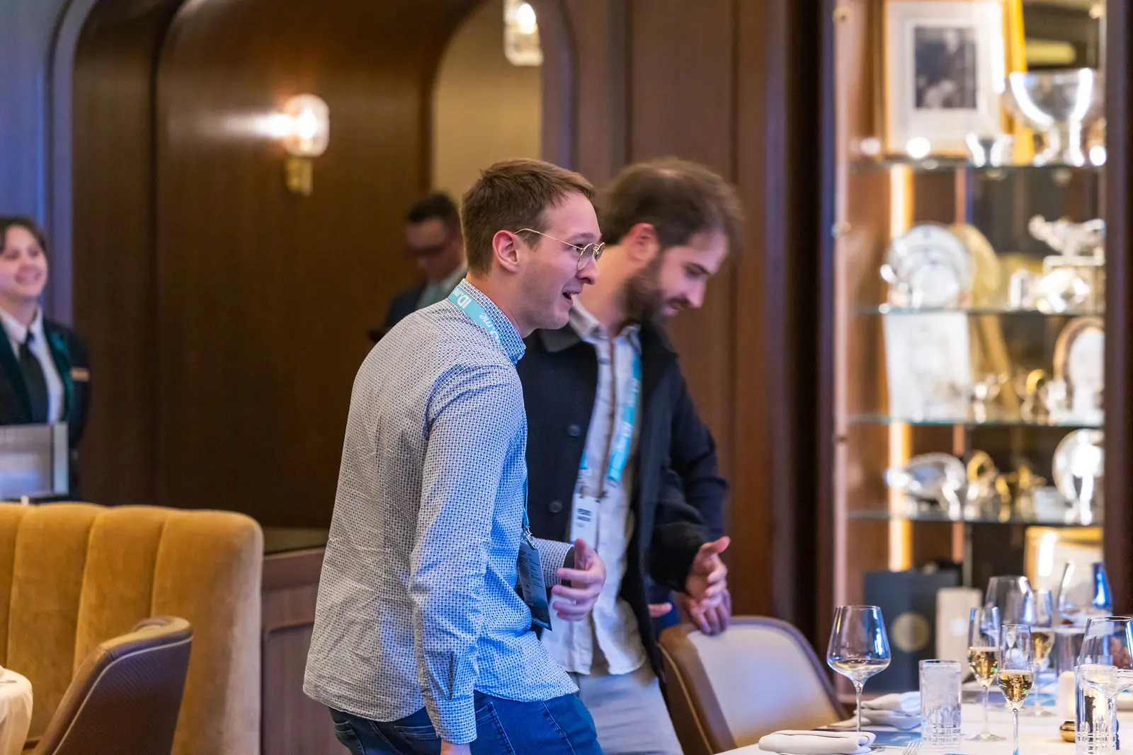 Two attendees laughing at the bar after dinner