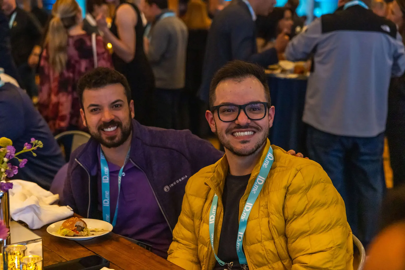 Two guests laughing across a Breakthru networking dinner table