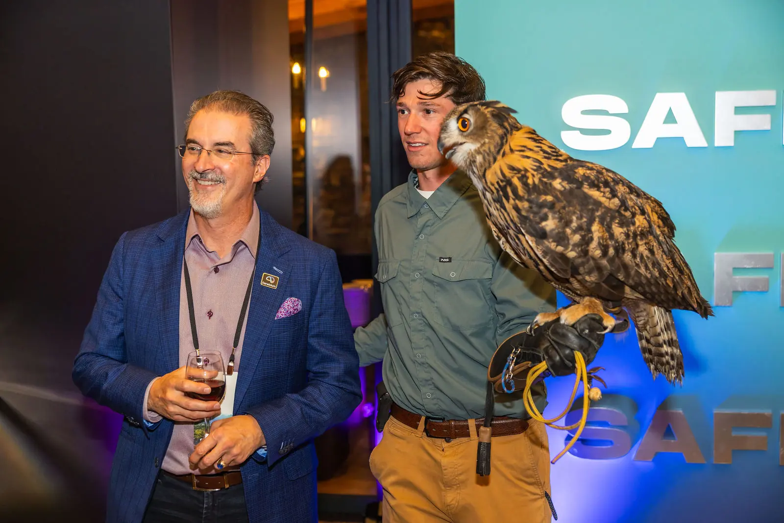 An attendee holding an owl at the falconry experience