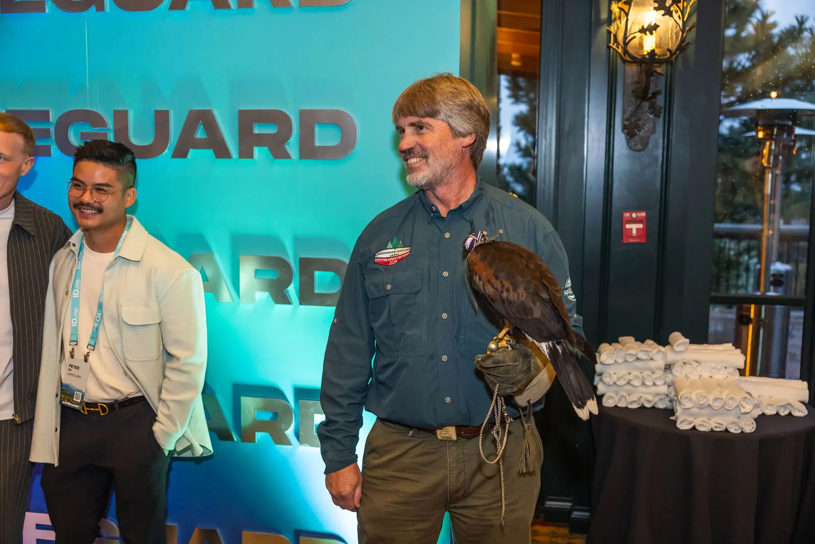 Two attendees with a hawk at the falconry experience