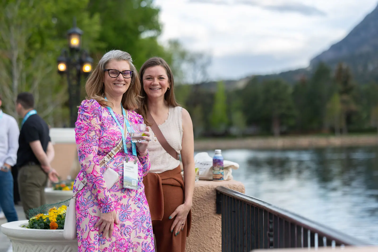 Two attendees talking beside the Broadmoor lake