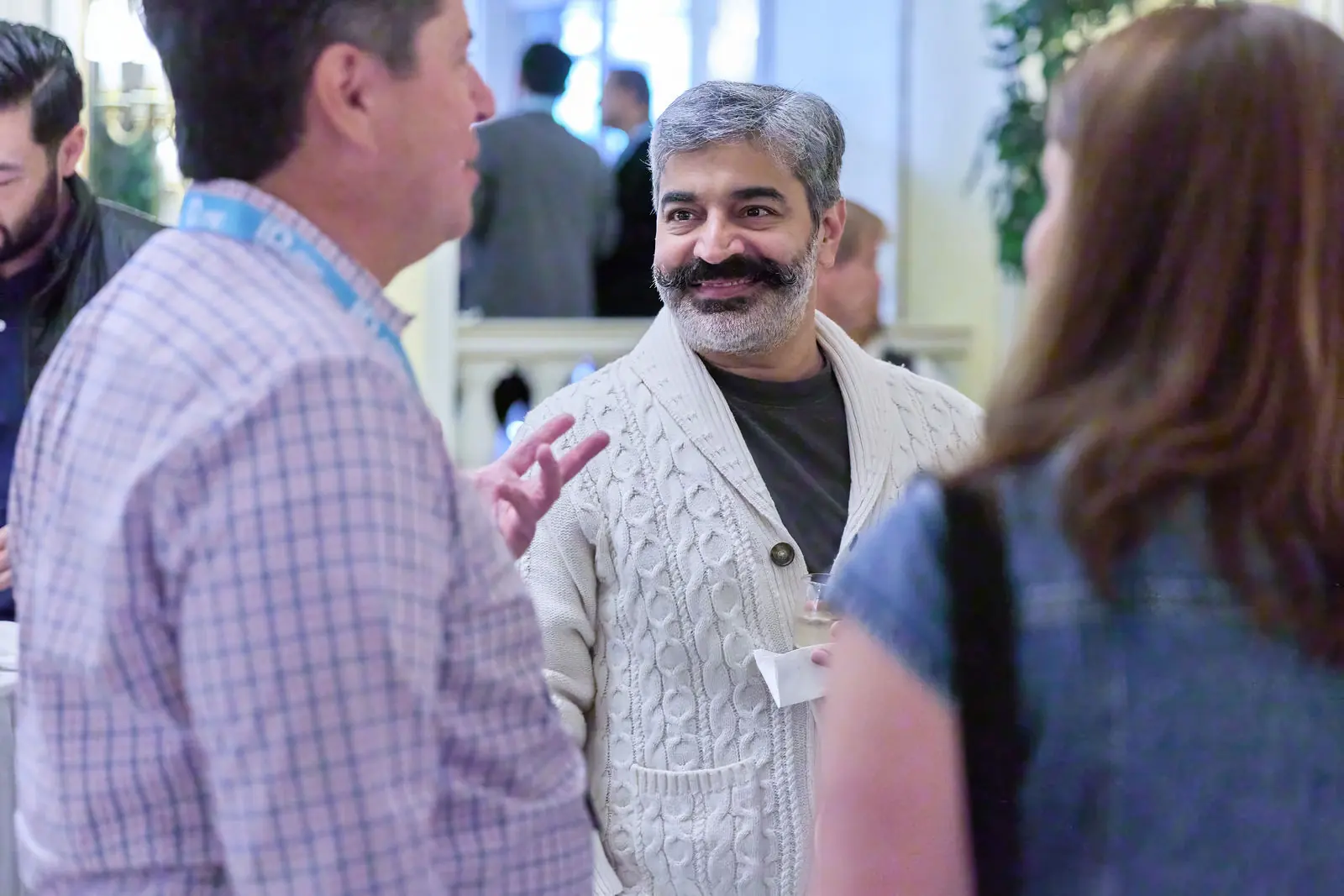 An attendee making a point at the evening reception