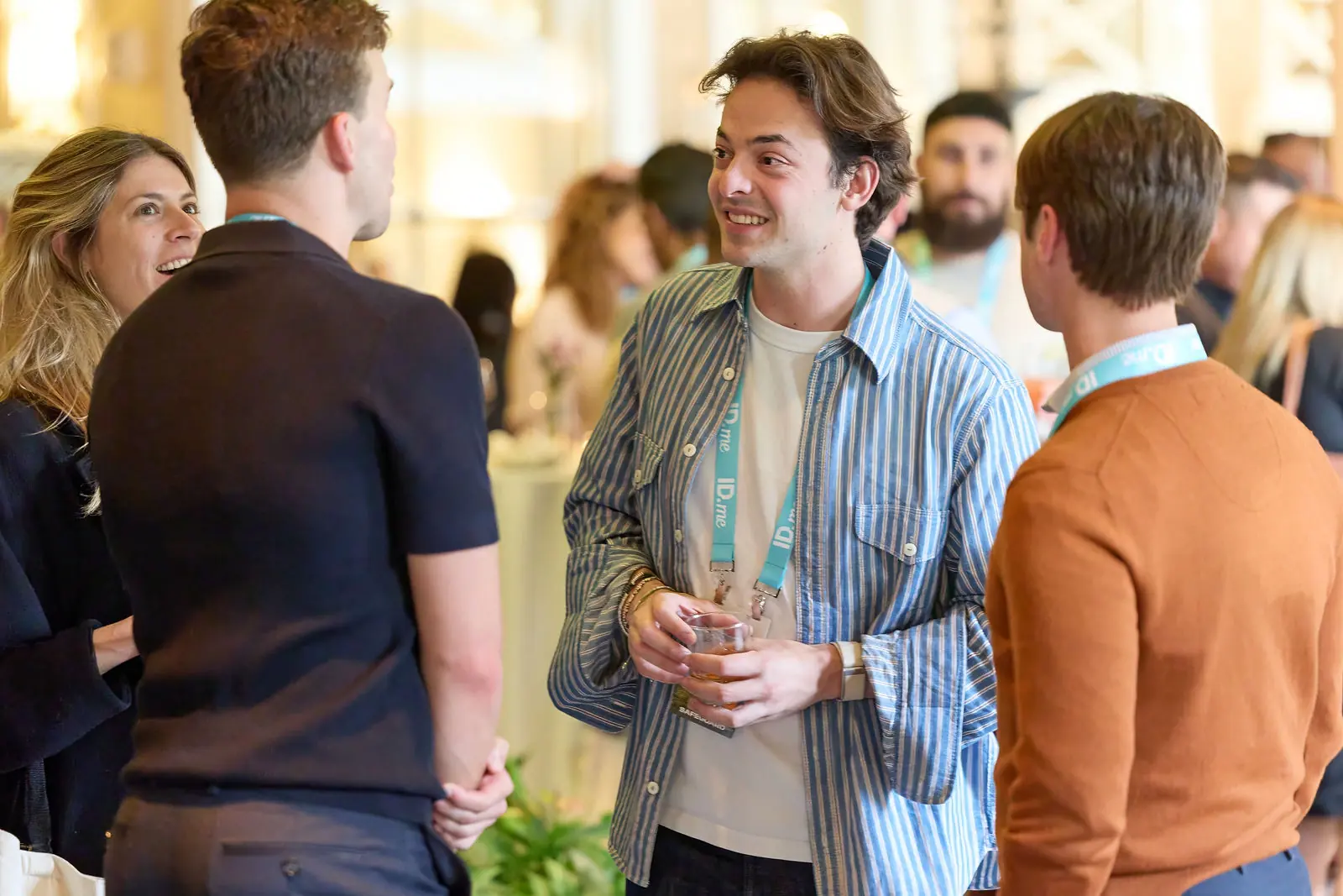 Three attendees talking at the opening reception