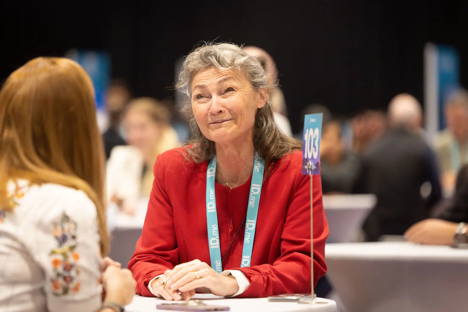 An attendee laughing mid-conversation at a Breakthru meeting table