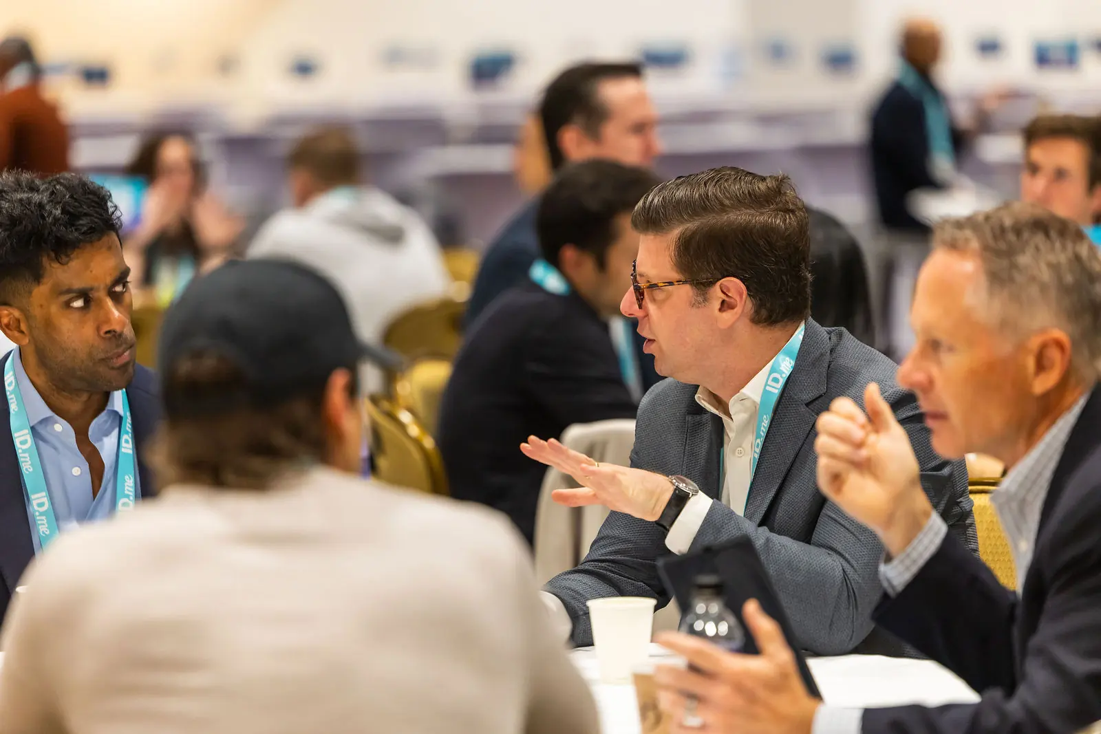 An animated exchange between two attendees at a roundtable