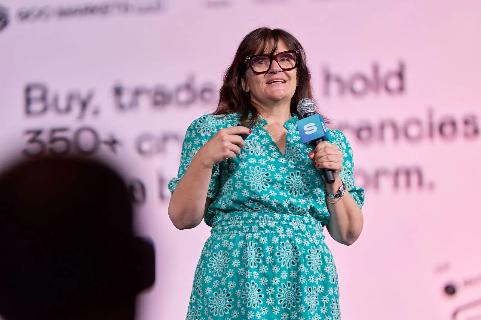 A speaker on the Safeguard stage holding the mic